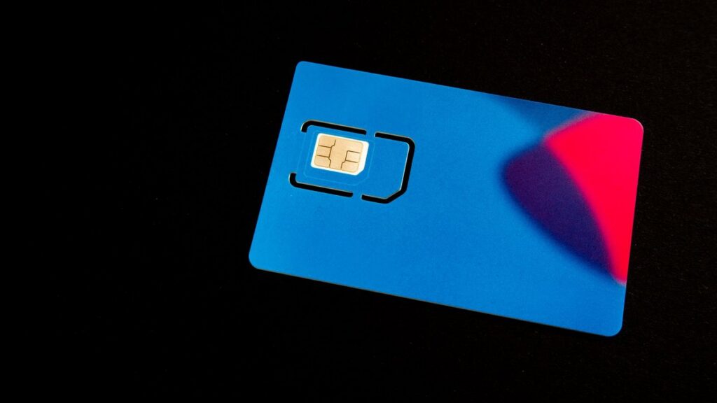 A blue SIM card on a dark background